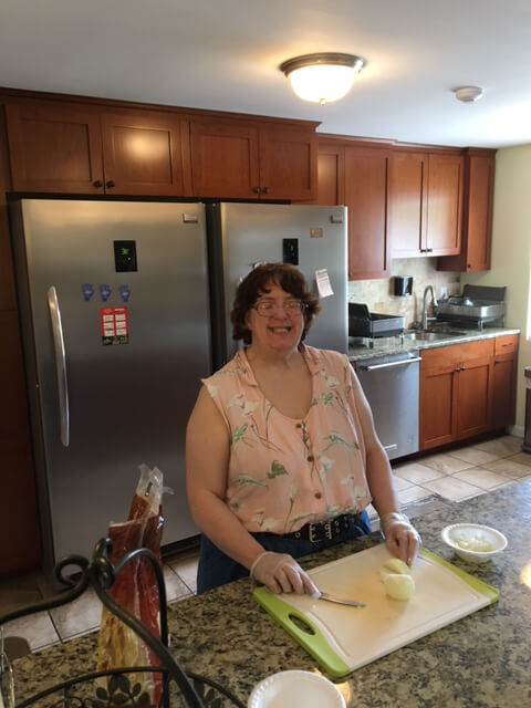 Participant chopping vegetables in kitchen