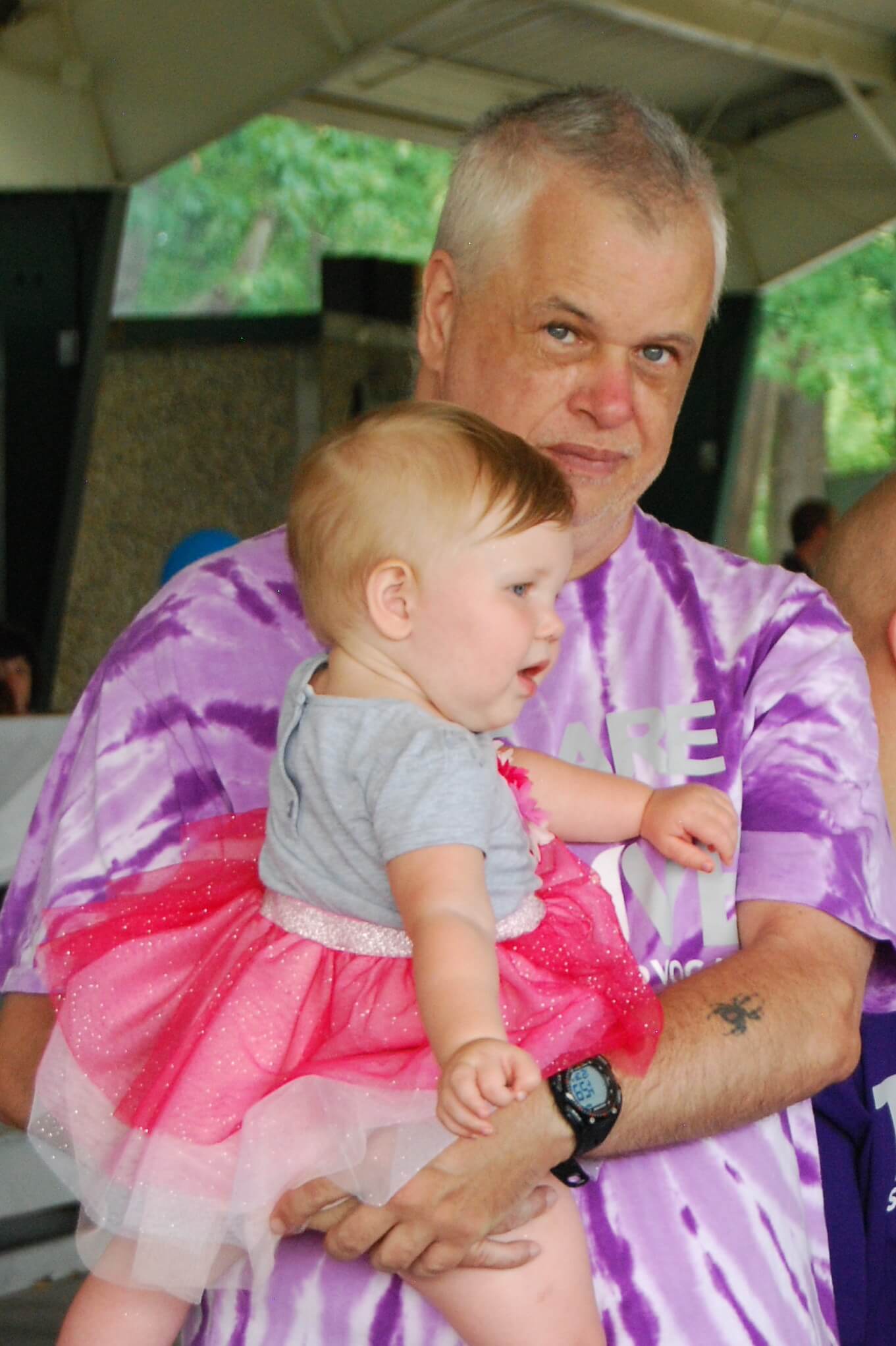 Thrive participant holding baby at FunFest event