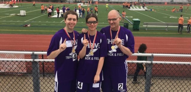 3 Special Olympics athletes pose with their medals