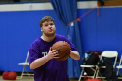 man shooting basketball